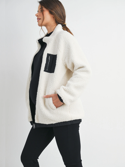 Veste polaire de grossesse bien chaude pour l'hiver de couleur blanc et noir avec une tirette et des poches