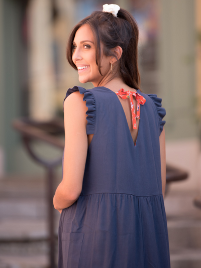 Navy maternity dress with floral bow
